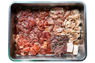 Various parts of raw sliced pork with marinated pork, pork belly, pork liver on tray
