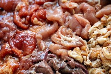 Various parts of raw sliced pork with marinated pork, pork belly, pork liver in stall