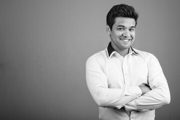 Portrait of Indian businessman against gray background