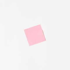 Pink sticker on a white wall, mock up. Blank sticky sheet, minimalism