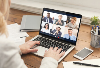 Businesswoman Having Meeting With Business People Via Laptop At Workplace