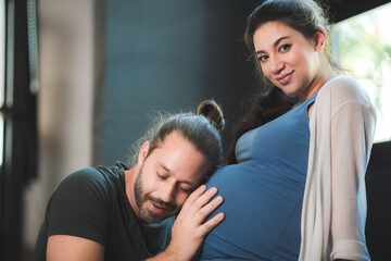 pregnant woman with her husband couple at home, family person pregnancy motherhood concept