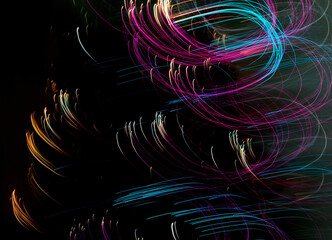 Abstract curved lines artistically created with colored christmas lights lights. Long exposure