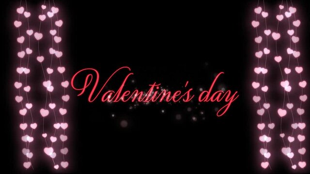 Animation of Valentine\\\'s Day written in pink letters on black background with two hearts garland