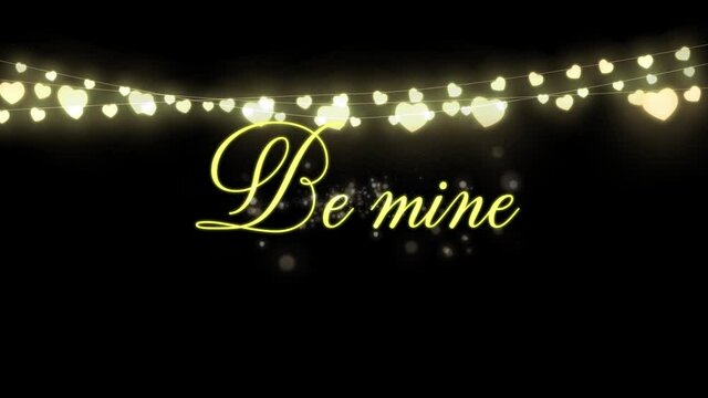 Animation of Be Mine written in golden letters on black background with a hearts garland