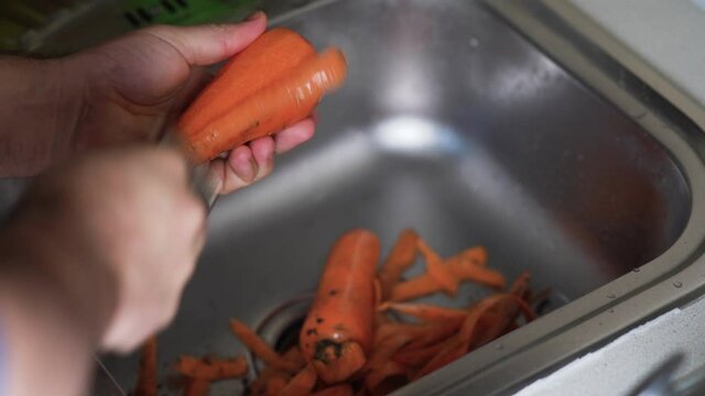 Hand Washing Carrots Under Running Water