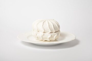 Russian traditional marshmallow dessert zefir souffle served on plate isolated on light background

