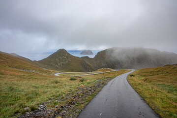 Fototapeta na wymiar Værøy with a road down the mountain