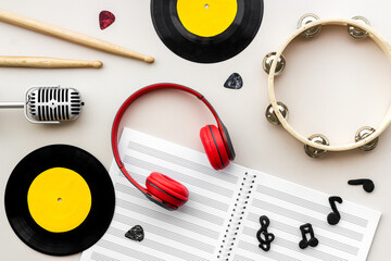 Music flat lay - instruments with vinyl records, overhead view