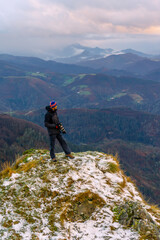 Fototapeta premium A photographer looking at the views of the snow-capped summit, on Mount Peñas de Aya in the town of Oiartzun near San Sebastián, Gipuzkoa. Basque Country