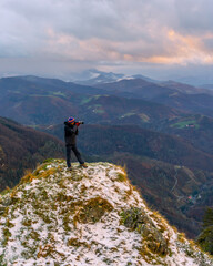 A photographer looking out from the snowy summit, on the Mount of Peñas de Aya in the town of Oiartzun near San Sebastián, Gipuzkoa. Basque Country