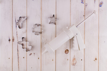 pastry syringe with molds on wood background