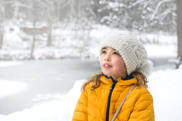 Young girl outdoor portrait. Woman face in winter nature.