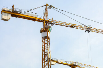 Industrial construction cranes and building. Working construction crane tower on the clear sky background