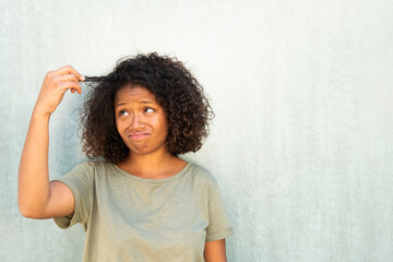 unhappy young African American woman pulling her hair