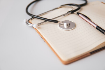 stethoscope on note book with white background