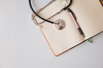 stethoscope on note book with white background