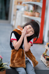 portrait asian kid, child enjoy and happy, the girl is smiling
