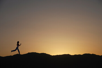 A woman is running silhouette