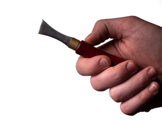 The shallow line edge tool for leather is in a man's hand. shallow line edge.