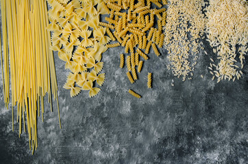 on black and white ground, auger pasta, pipe pasta, spaghetti, bow tie pasta