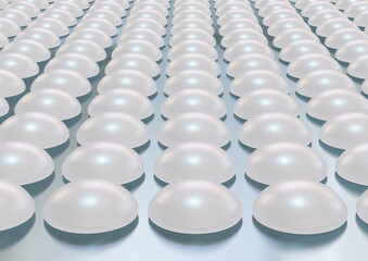 Silicone breast implant stacked on a stainless steel table