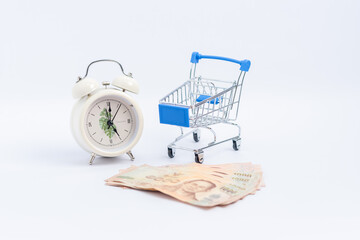 Thai banknotes are empty on the cart And there is a clock telling the time next to it / an...