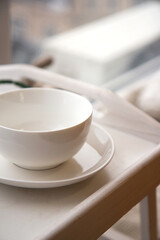Fototapeta na wymiar Large white ceramic cup on a saucer on a tray. Cozy home background. Still life from home interior