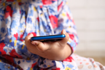 Child girl watching cartoon on smart phone 