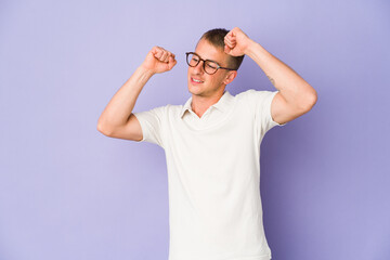 Naklejka premium Young caucasian handsome man celebrating a special day, jumps and raise arms with energy.