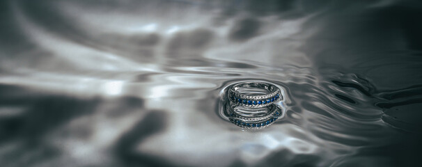the ring lies in the water on a mirror surface