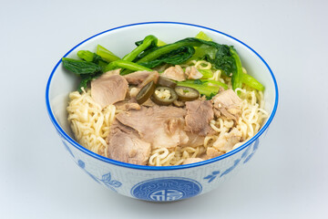 Noodles in a bowl with chinese patterns on a white background