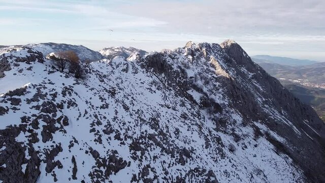 paragliders flying high over the mountains in winter (aerial video)