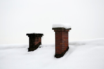 closeup of chimneys covered with snow