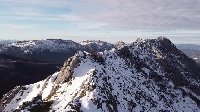 paragliders flying high over the mountains in winter (aerial video)