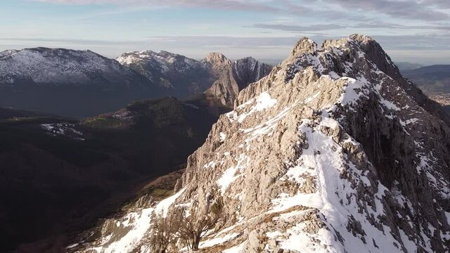 aerial shot of snowy mountains in the basque country, northern spain