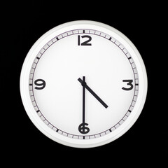 White round analog wall clock isolated on black background.