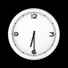 White round analog wall clock isolated on black background.