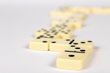 A game of dominoes on a light background. Close-up. Selective focus.