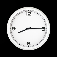 White round analog wall clock isolated on black background.
