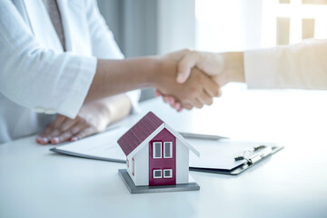 Real estate agents and buyers handshake after signing a business contract, renting, buying, mortgage, loan or home insurance