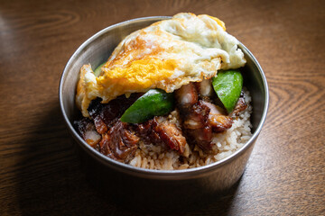 Chinese bbq sweet pork serve with a fried egg and white rice. Cantonese cuisine.