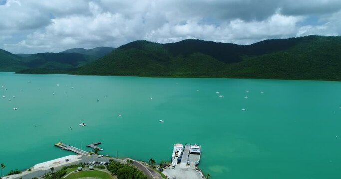 4K reverse tracking aerial view over the waters of Shute Harbour and moored boats in bay,Whitsundays,Queensland,Australia