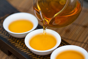 Tea pouring into tea cup