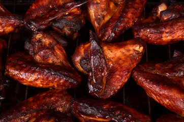 Grilled chicken wings on a baking sheet. Roasted in oven crispy sticky honey chicken wings, top view