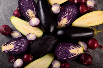 Still life of fresh purple vegetables on a gray background. Collection of fresh purple vegetables, Vegetable background