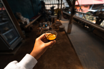 Espresso coffee is flowing into the shot cup.