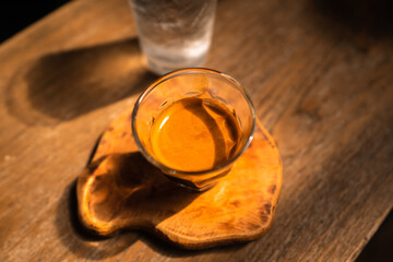 Espresso coffee is flowing into the shot cup.