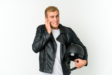 Young caucasian man holding a motorbike helmet isolated on white background