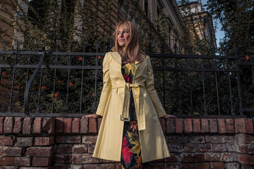 Beautiful and gorgeous young fashionable female outdoors in city wearing new clothing. Girl with style.